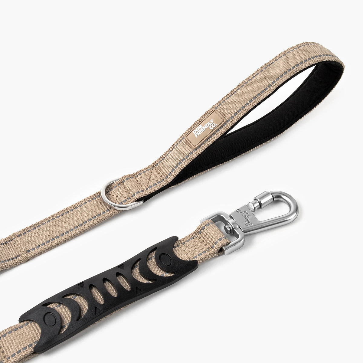 Close-up of the padded handle, metal D-ring and heavy-duty clip on a premium brown bungee dog leash.