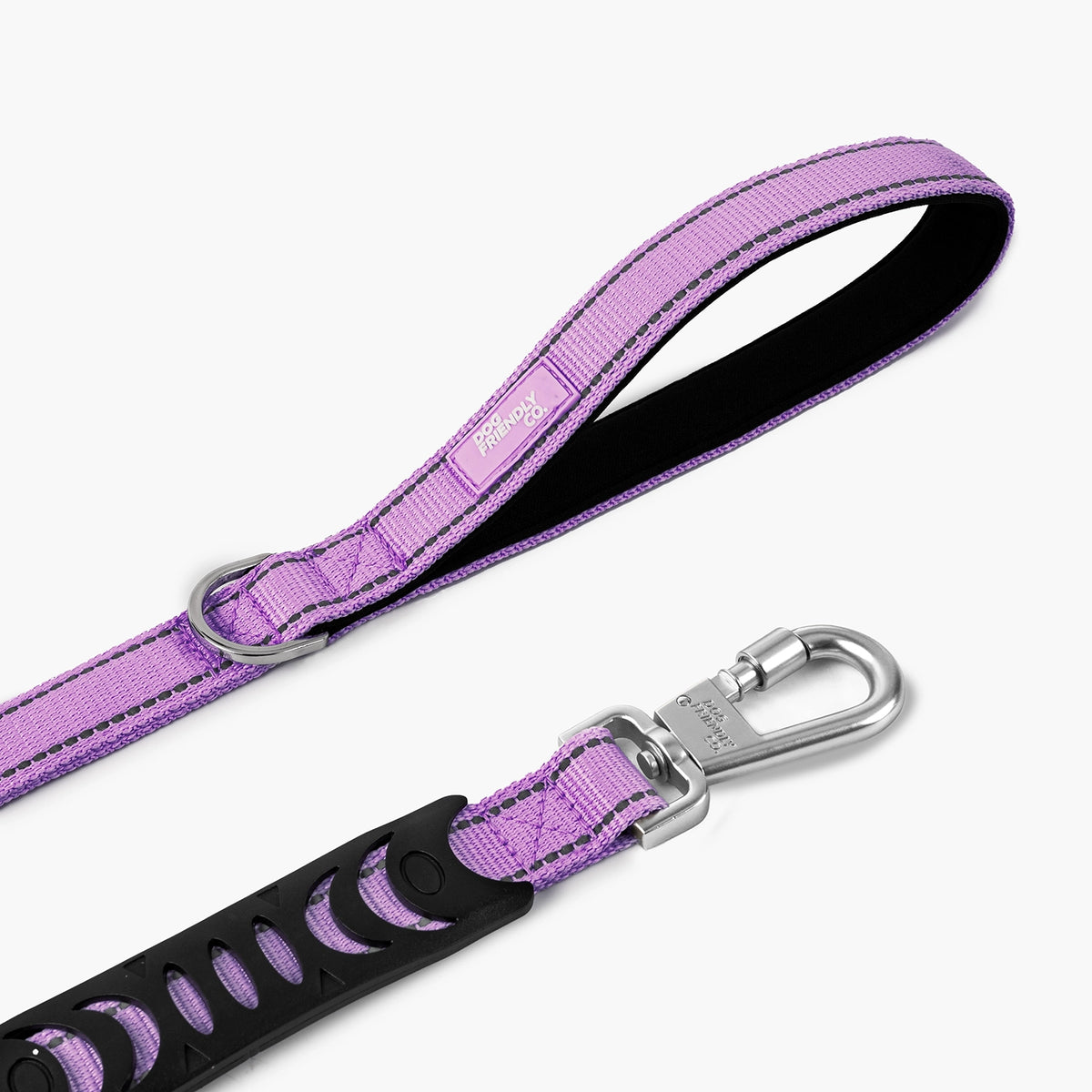 Close-up of a purple bungee dog leash showing the padded handle, metal D-ring and heavy-duty clip.