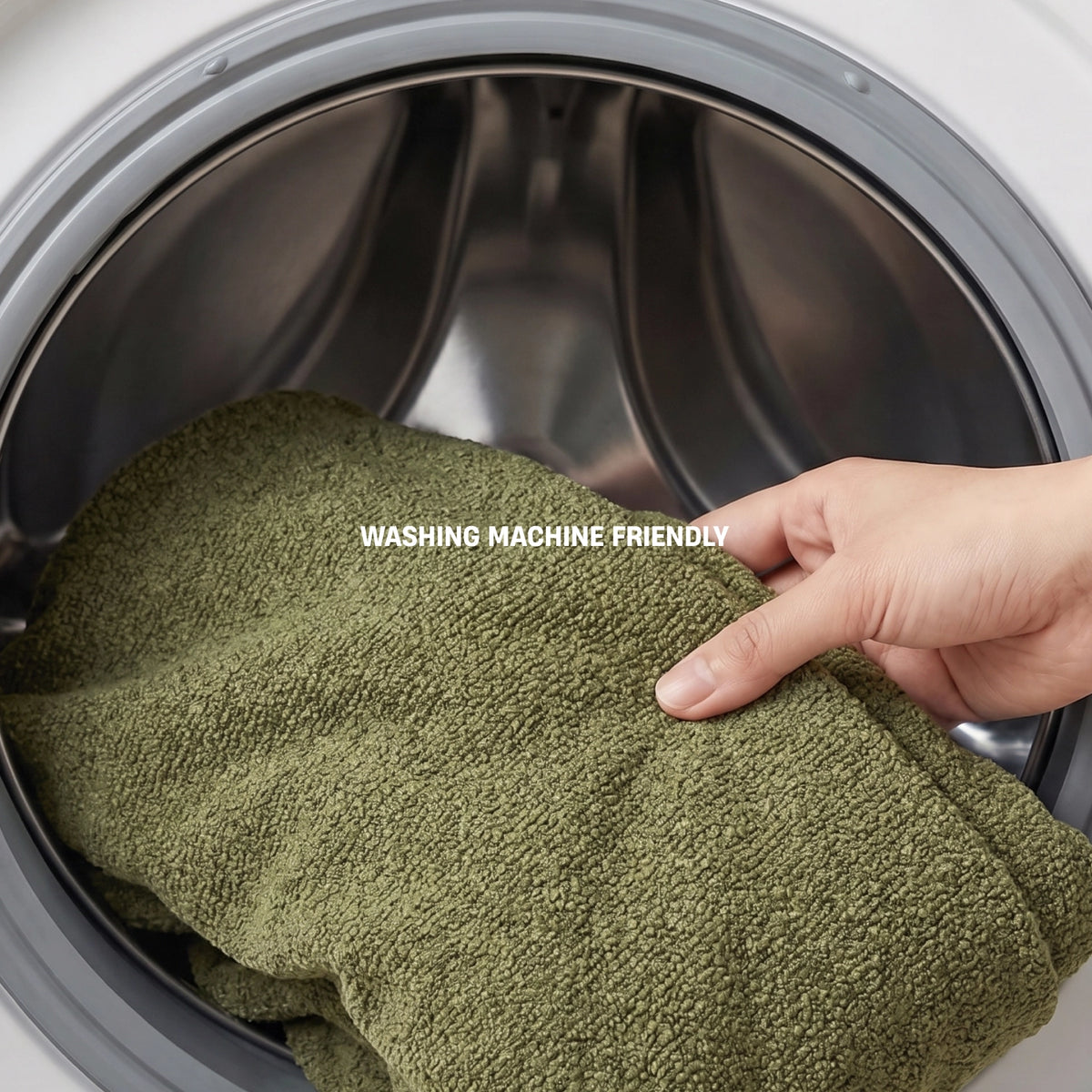 Green bouclé replacement cover being removed for machine washing.
